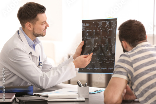 Doctor consulting male pati...