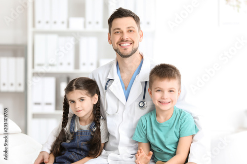 Children's doctor with little kids in hospital