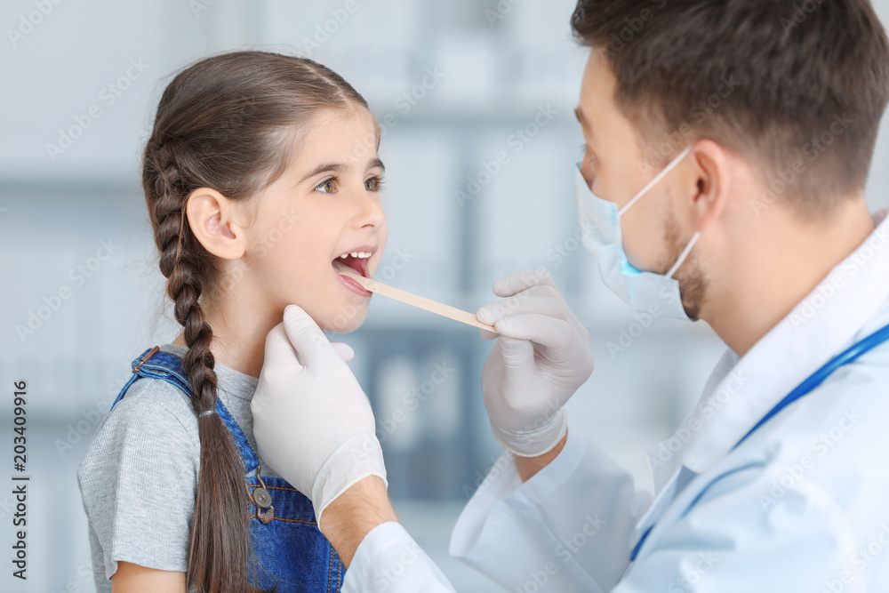 Children's doctor examining little girl in hospital Children's doctor examining little girl in hospital