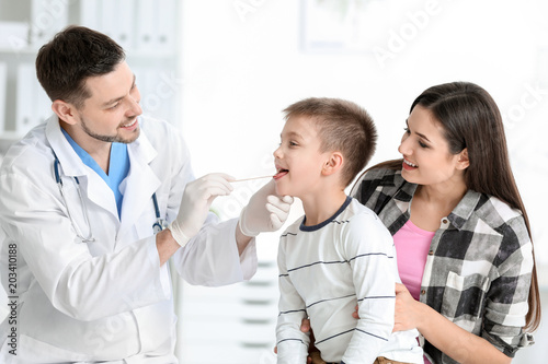 Doctor examining little boy in hospital