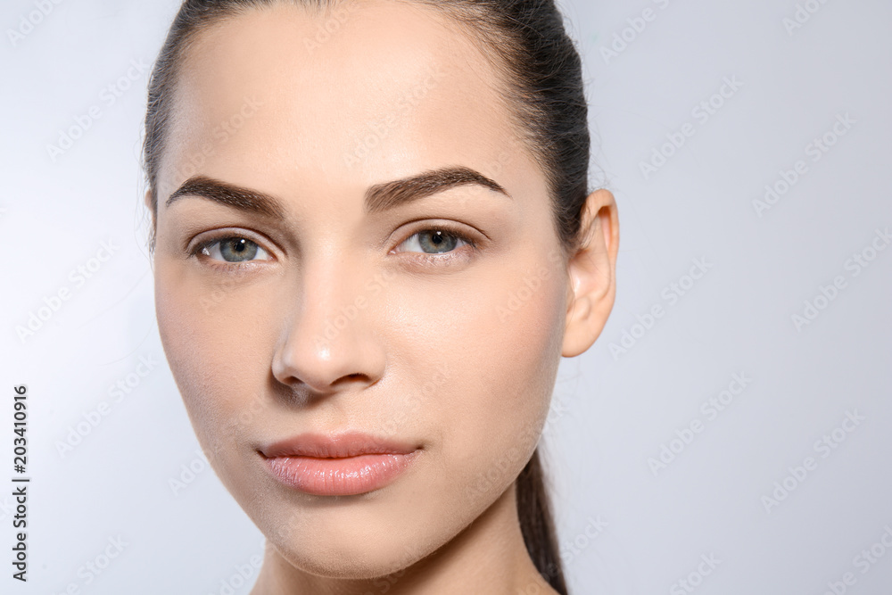 Beautiful woman with perfect eyebrows on light background Beautiful woman with perfect eyebrows on light background