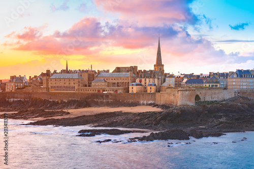 Beautiful view of walled city Saint-Malo with St Vincent Cathedral at sunrise at high tide. Saint-Maol is famous port city of Privateers is known as city corsaire, Brittany, France