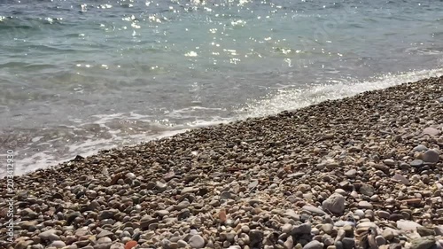 Adriatic sea surf. Sea waves runs on coastal pebble.