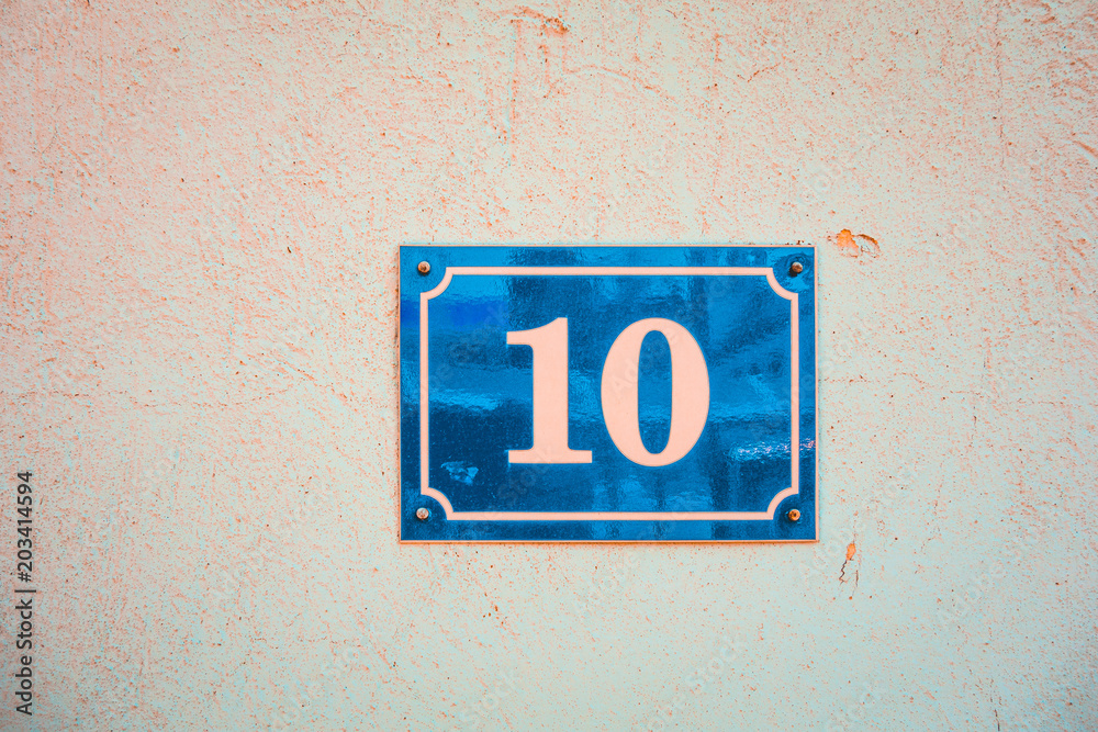 number 10 door entrance sign on white facade number 10 door entrance sign on white facade