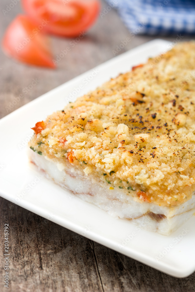 White fish casserole with cheese on wooden background. White fish casserole with cheese on wooden background.