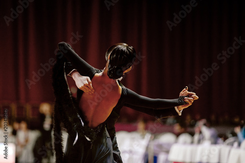 Canvas Print back female dancer in black ball gown ballroom dancing competition