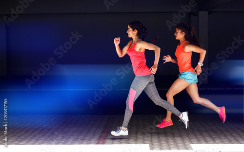 Two female runners jogging.Fitness and jogging concept.Copy space.
