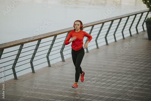 Active young beautiful woman running in urban enviroment