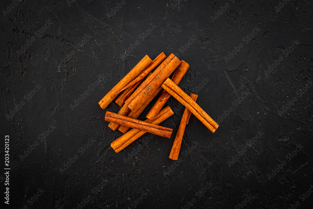 Cinnamon sticks on black background top view copy space. Condiment for mulled wine Cinnamon sticks on black background top view copy space. Condiment for mulled wine