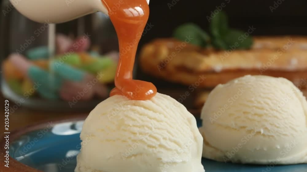 bowl of white vanilla ice cream pour caramel sauce