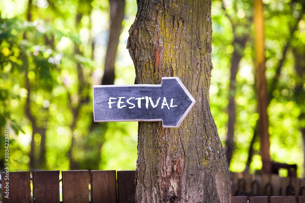 Summer festival, wooden sign on tree
