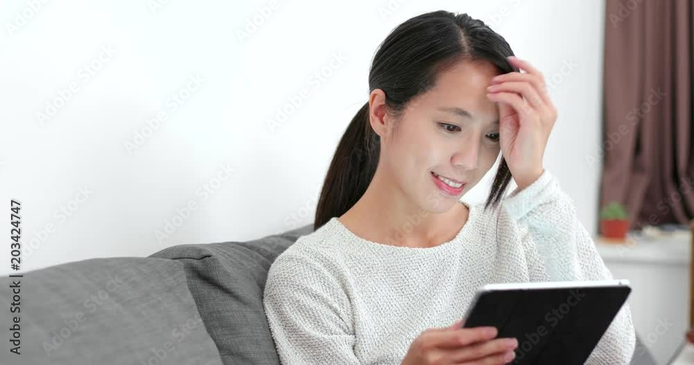 Woman enjoy the movie of tablet computer at home Woman enjoy the movie of tablet computer at home