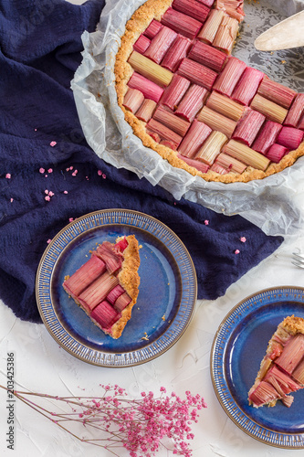 
Rhubarb pie, cake, tart. White background, blue plates and napkin.