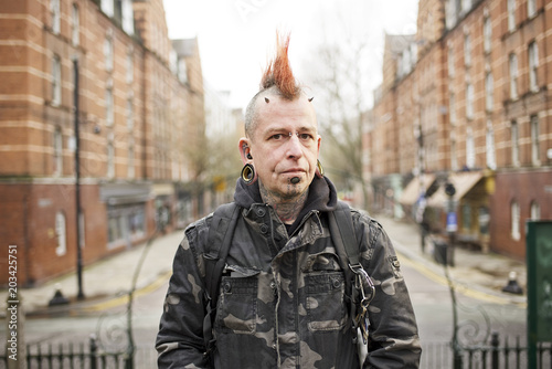 Portrait of tattooed man wearing ear plugs