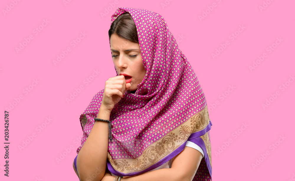 Young arab woman wearing hijab sick and coughing, suffering asthma or bronchitis, medicine concept Young arab woman wearing hijab sick and coughing, suffering asthma or bronchitis, medicine concept