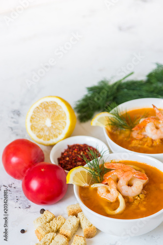 Lentil soup with seafood. Red soup with shrimps and squid