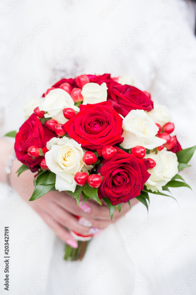 Wedding bouquet with roses in the hands of the bride Wedding bouquet with roses in the hands of the bride