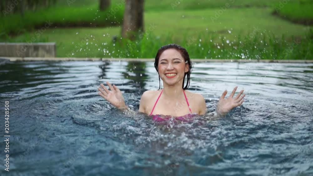 slow motion of woman in swimming pool and playing water splash slow motion of woman in swimming pool and playing water splash