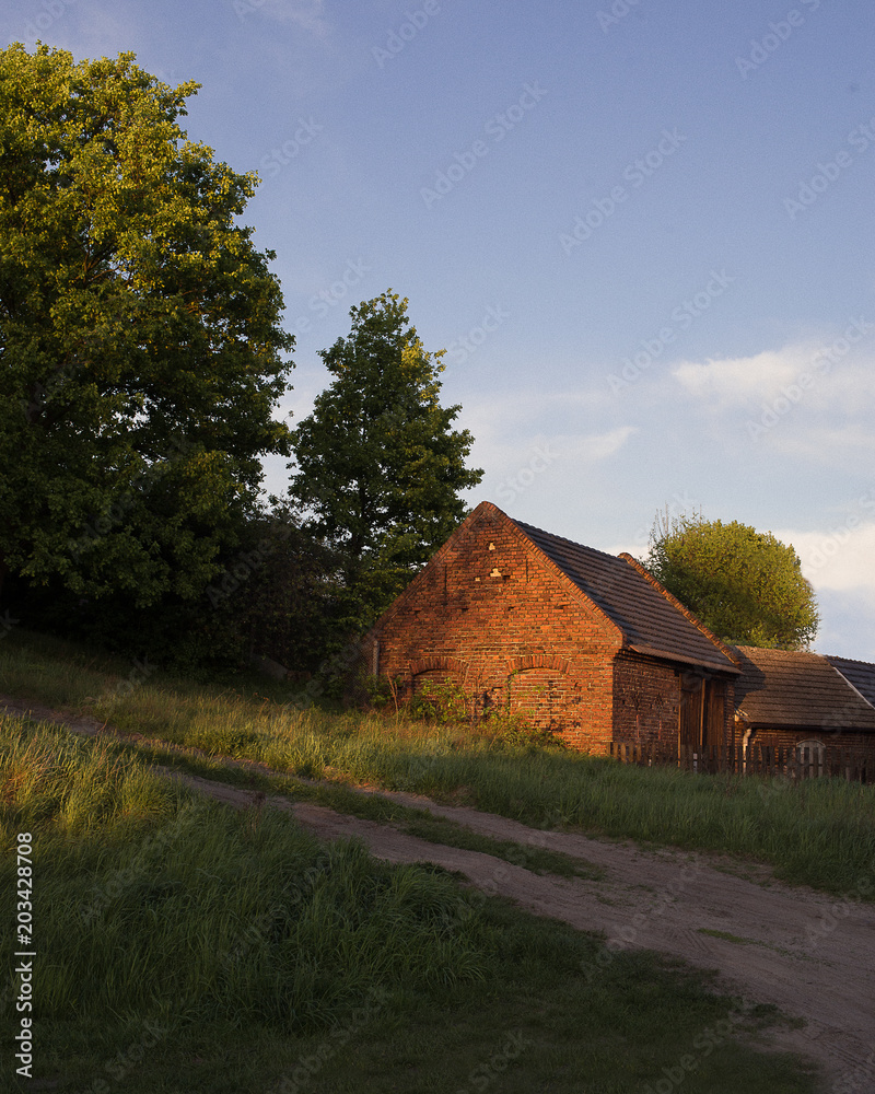 Fototapeta premium Brick house in the sunset