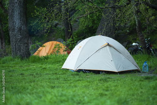 Tents on a picturesque green meadow