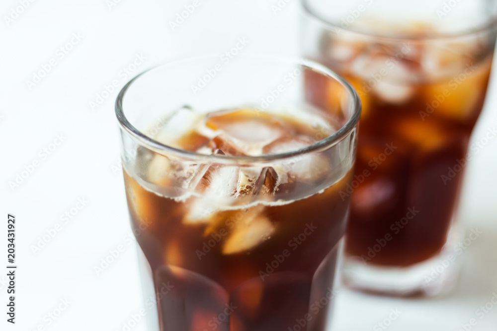 Coffee with ice on light background. Cold brew close up Coffee with ice on light background. Cold brew close up