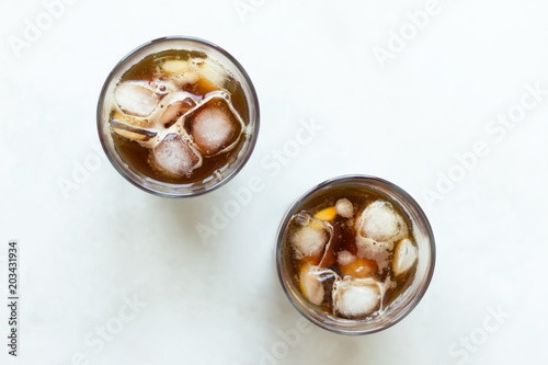 Cold brew. Coffee with ice on light background. Top view