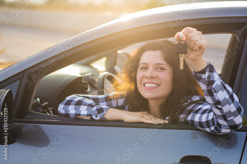 Obraz na plátně Young woman test drive new car and showing key