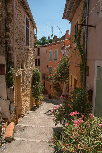 View of stone houses in alley on the slope under blue sky  at the gorgeous medieval hamlet of Les Arcs-sur-Argens  near Draguignan. Located in the Provence region  Var department  southeastern France