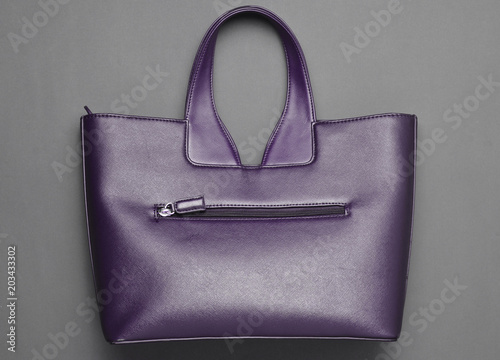 Fashionable leather bag on a gray paper background. Top view.