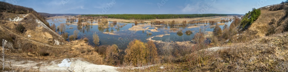Spring landscape, panorama - spring flood in river valley of the Siverskyi (Seversky) Donets, the winding river over the meadows between hills and forests, border region of Ukraine near to Russia Spring landscape, panorama - spring flood in river valley of the Siverskyi (Seversky) Donets, the winding river over the meadows between hills and forests, border region of Ukraine near to Russia