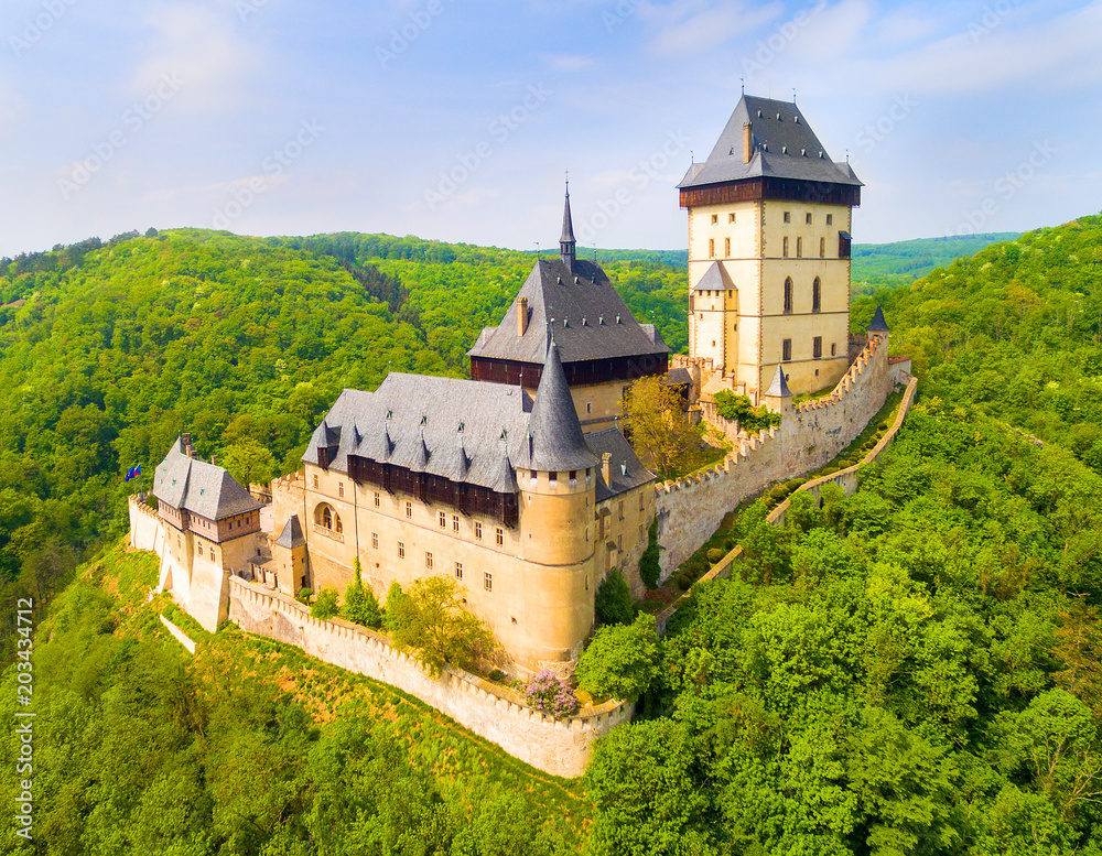 Fototapeta premium Aerial view to The Karlstejn castle. Royal palace founded King Charles IV. Amazing gothic monument in Czech Republic, Europe.