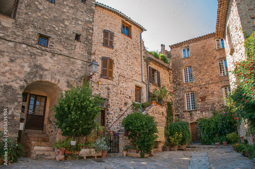 View of old stone houses in alley under shadow, at the gorgeous medieval hamlet of Les Arcs-sur-Argens, near Draguignan. Located in the Provence region, Var department, southeastern France
