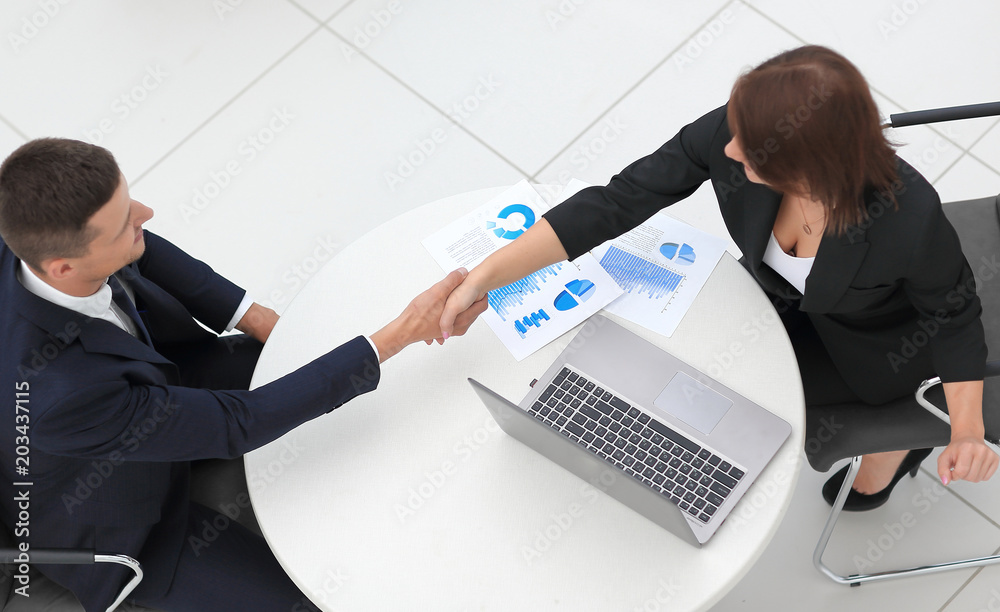 handshake business partners after the discussion of financial documents. handshake business partners after the discussion of financial documents.
