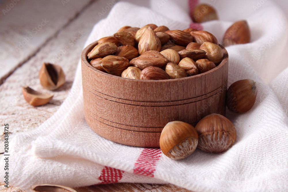 Peeled hazelnuts on the background of wood. useful snack, proper nutrition. how to peel the nuts. Peeled hazelnuts on the background of wood. useful snack, proper nutrition. how to peel the nuts.
