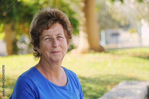 close up portrait of senior woman sitting in outdoor summer cafe