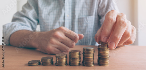 Finances and budgeting, businessman stacking coins