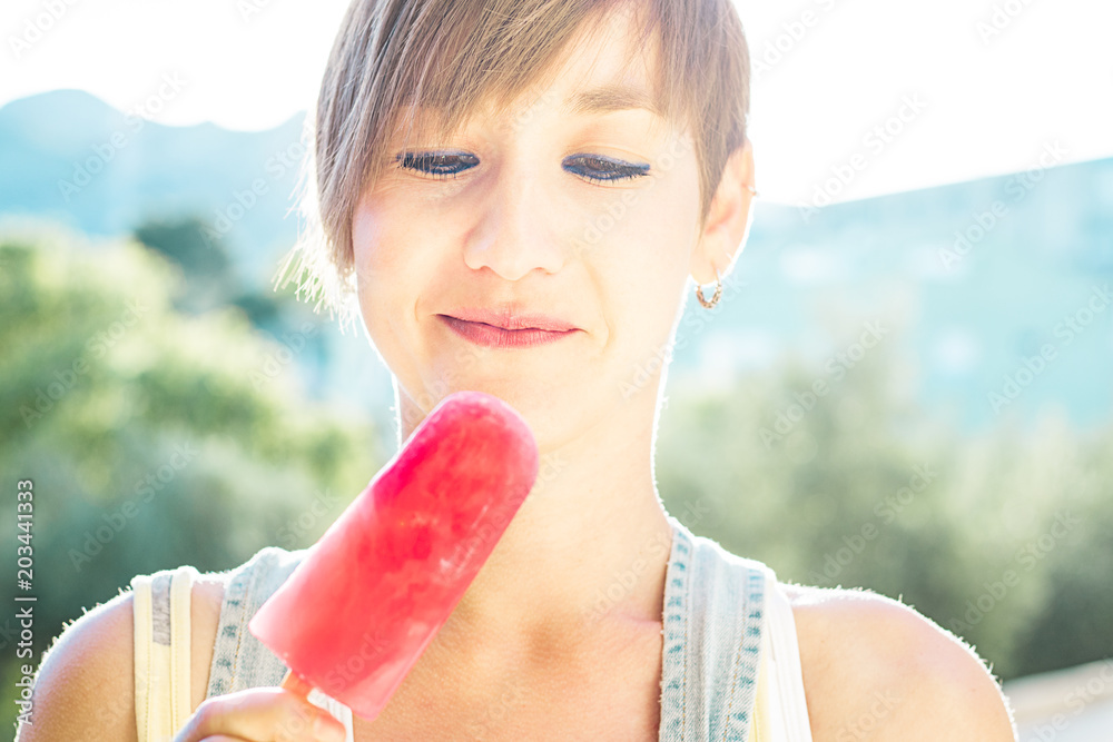 Young girl eating an ice cream popsicle Young girl eating an ice cream popsicle