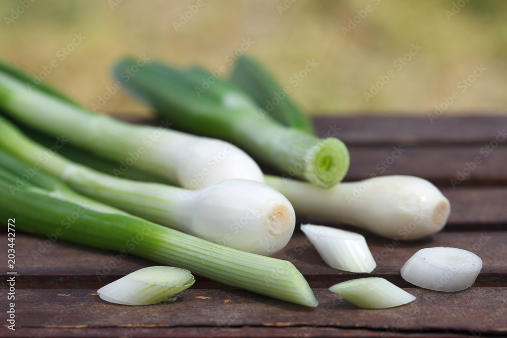 Fresh healthy spring onions on wooden table, outdoor image.Choped green onions. Fresh healthy spring onions on wooden table, outdoor image.Choped green onions.