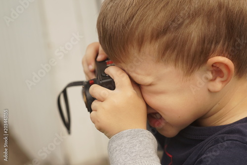 Child Taking A Picture Using A Retro Camera photo