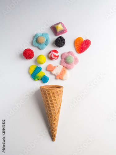 Ice cream cone with jelly candies on white background