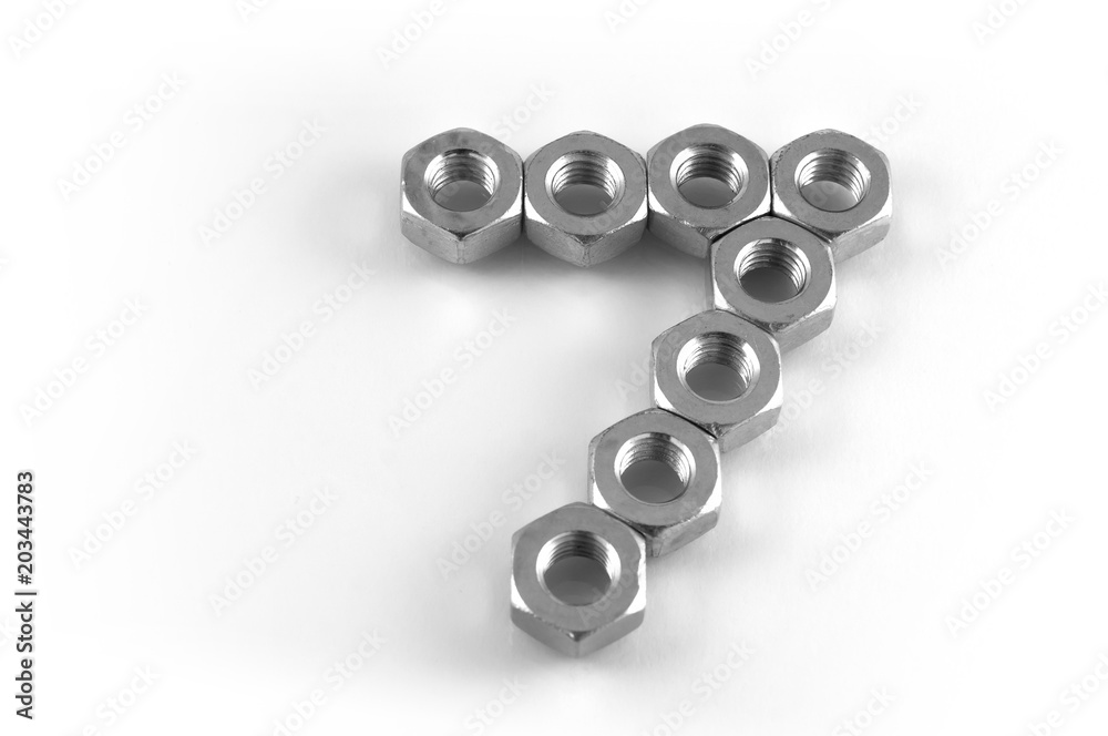 Digit seven or the arrow to the right and up, lined with steel hex nuts on a white background. Digit seven or the arrow to the right and up, lined with steel hex nuts on a white background.