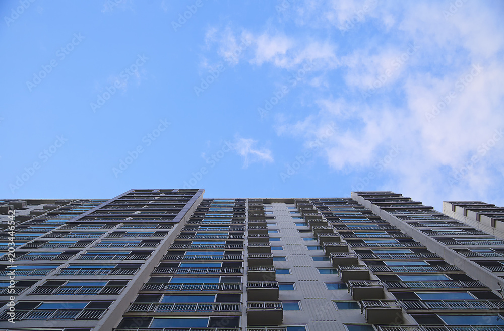 Background of fine dust-free clear sky, low angle view of apartment building