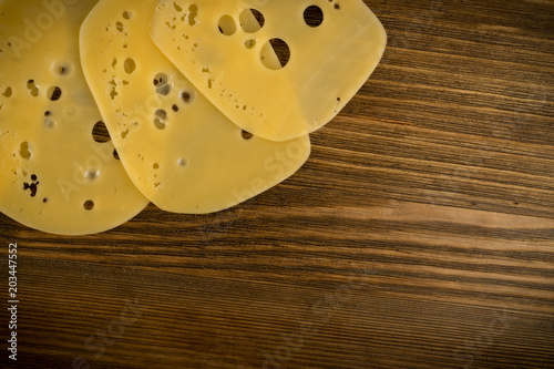Sliced Cheese Over Rustic Wooden Background