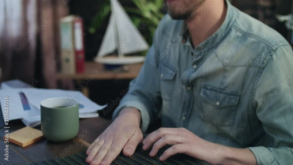Man hitting folder with documents on negotiating table during business meeting. Close up business team talking on office meeting about successful work results. Happy workers enjoy business agreement Man hitting folder with documents on negotiating table during business meeting. Close up business team talking on office meeting about successful work results. Happy workers enjoy business agreement
