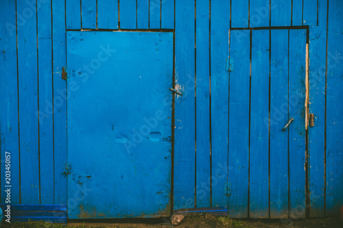 blue wooden wall with two doors photo