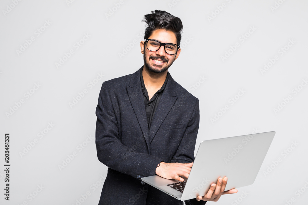 Young indian business man with laptop in hands isolated on white background Young indian business man with laptop in hands isolated on white background