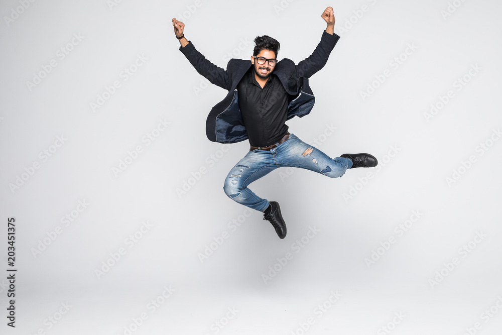 Excited Indian businessman jumping for joy isolated on white background.