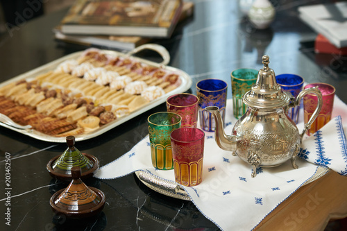 Traditional Moroccan tea with Ramadan cookies on festive silver tray. 