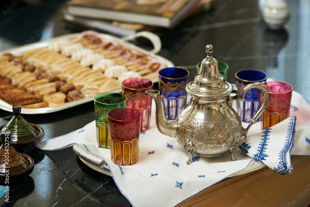 Traditional Moroccan tea with Ramadan cookies on festive silver tray.  