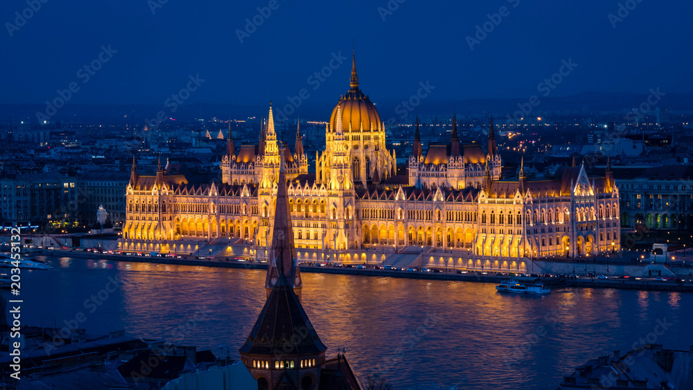 Parliament of Budapest after sunset seen from the opposite river bank